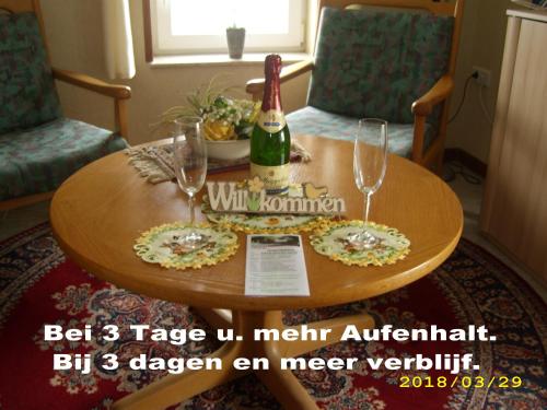 a table with a bottle of wine and two glasses at B & B Gross Methling in Dargun