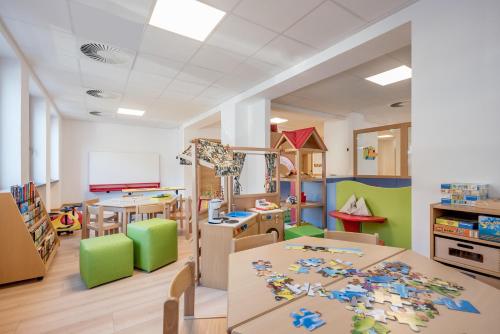 a kindergarten classroom with tables and chairs and toys at Hotel Alpina deluxe in Obergurgl