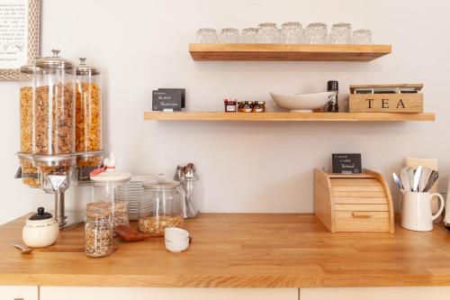 a kitchen with a counter top with jars of food at Harriet House B&B in Canterbury