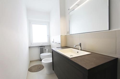 a bathroom with a sink and a toilet at Hostdomus - Green Tech Apartment in Sestriere