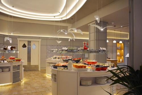 a restaurant with a buffet of food on display at SH Villa Gadea in Altea