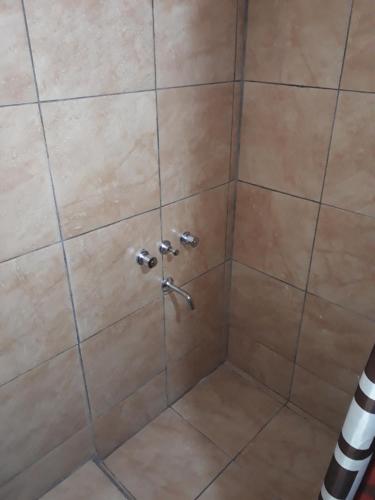 a shower with a shower head in a bathroom at Colores de Fiambala in Fiambala