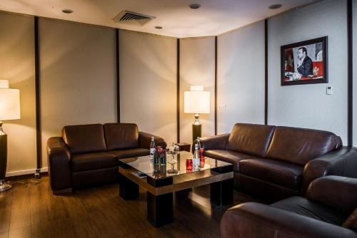 a waiting room with leather chairs and a table at Kenzi Tower Hotel in Casablanca