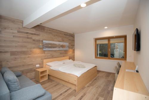 a bedroom with a bed and a couch at Vila Alpina in Bled