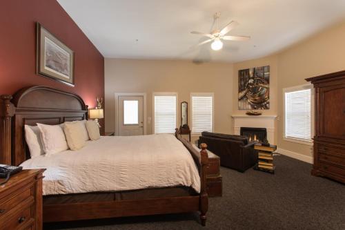 a bedroom with a bed and a chair and a fireplace at Gruene River Hotel & Retreat in New Braunfels
