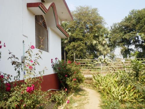 a house with flowers on the side of it at Senamura Yoga Ashram Guesthouse in Bodh Gaya