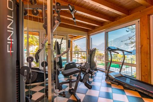 a gym with treadmills and ellipticals in a house at Hotel Riviera Panoramic Green Resort in Limone sul Garda