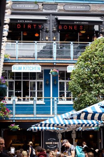 a group of people standing in front of a blue building at The Z Hotel Tottenham Court Road in London