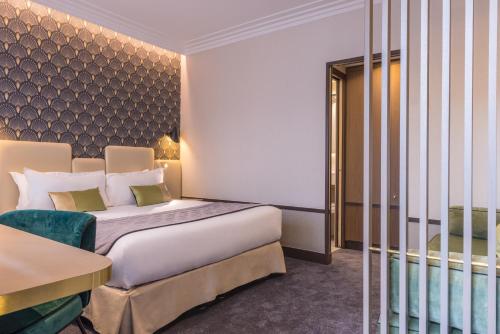 a hotel room with a bed and a chair at Best Western Select Hotel in Boulogne-Billancourt