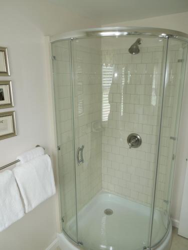 a shower with a glass door in a bathroom at Victoria Inn in Hampton