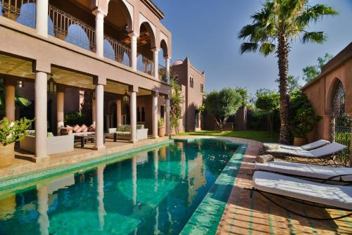 a swimming pool in front of a house at Residence Dar Lamia Marrakech in Dar Caïd Layadi
