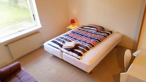 a bedroom with a bed with a blanket on it at Struer Town House in Struer
