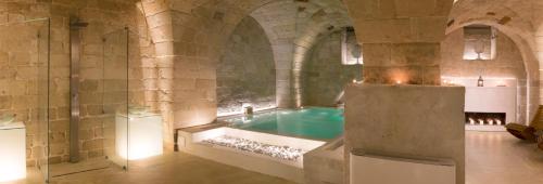 a large bathroom with a tub in a building at ReLuxe Private Wellness in Lecce