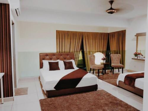 a bedroom with a bed and a table and chairs at Evo Bangi Duplex Homestay D' Imahzzz - 3BR or 2BR in Bangi