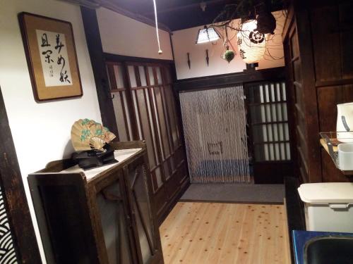 a room with a wooden floor and a hallway with a door at Kyoto Villa Ninja in Kyoto