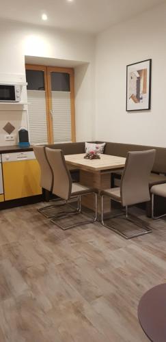 a room with a table and chairs and a kitchen at Ferienwohnungen Trinker - Lungau Karte inklusive in Ramingstein