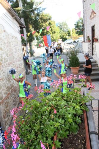 a group of children in colorful dresses standing in a garden at Casa Vacanze Antico Poggio in Poggio San Giovanni