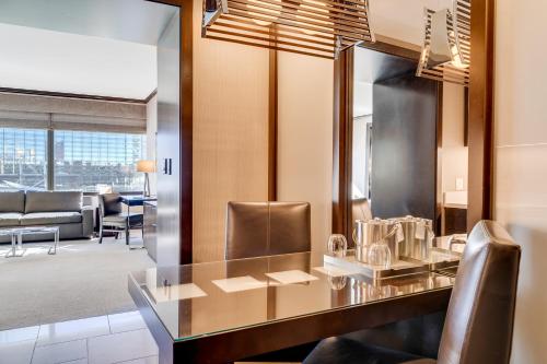 a dining room with a table and leather chairs at Jet Luxury at The Vdara in Las Vegas