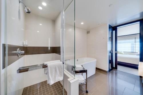 a bathroom with a shower and a tub and a toilet at Jet Luxury at The Vdara in Las Vegas
