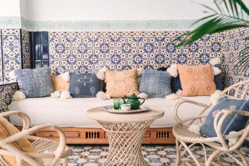 a living room filled with furniture and flowers at Riad Be Marrakech in Marrakesh