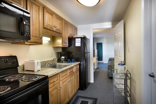 a kitchen with a sink and a stove top oven at Palms Resort in Myrtle Beach