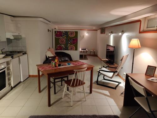 a kitchen and living room with a table and chairs at Yrjänäntie Home Apartment in Oulu