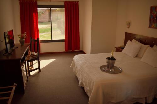 a bedroom with a bed with a candle on it at Villa de Merlo All Inclusive & Spa by MH in Merlo