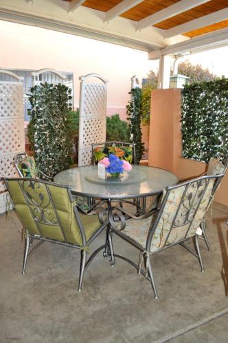 a glass table and chairs on a patio at Wingate by Wyndham Farmington NM in Farmington