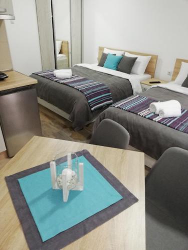 a living room with two beds and a table at Vila Vrh in Crni Vrh
