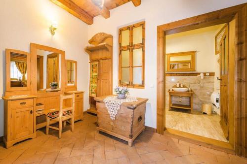 a bathroom with a large shower and a wooden table at Casa Savri in Sighişoara