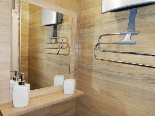 a bathroom with two lights and a mirror at Vila Vrh in Crni Vrh