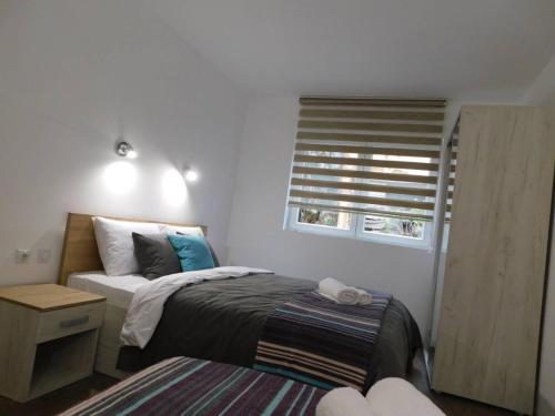 a small bedroom with a bed and a window at Vila Vrh in Crni Vrh