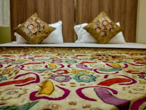 a bed with two pillows on top of it at Dwivedi Hotels Palace On Steps in Varanasi