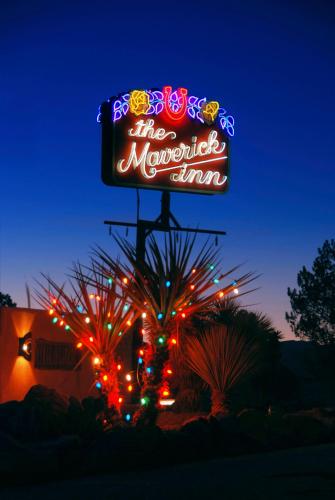 a sign for the muppet show with christmas lights at The Maverick Inn in Alpine