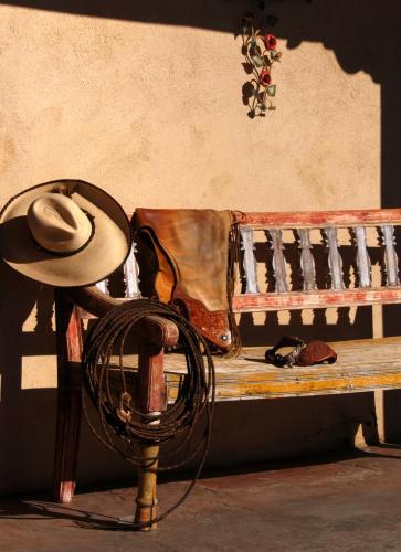 a hat and a purse sitting on a bench at The Maverick Inn in Alpine