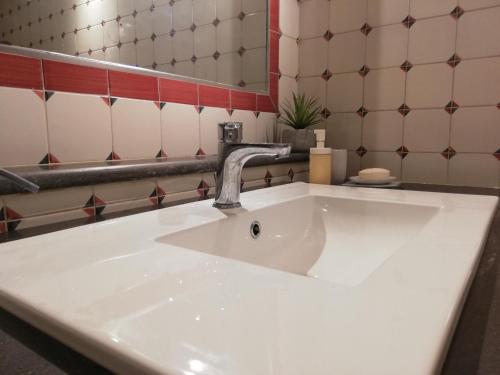 a white sink in a bathroom with a mirror at B&B VICOLO STRETTO in Salerno