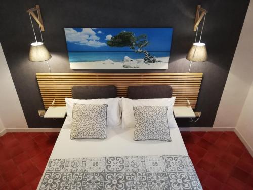 a bedroom with a white bed with two pillows at B&B VICOLO STRETTO in Salerno