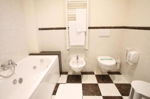 Hotel Isola Di Caprera في ميرا: حمام مع حوض ومرحاض ومغسلة