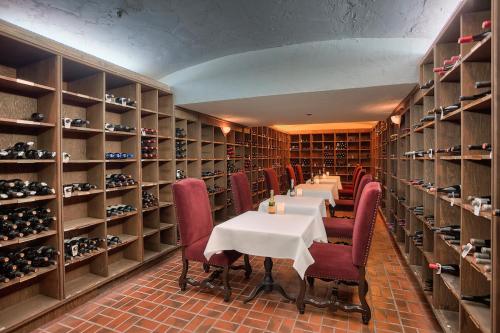a dining room with tables and shelves of wine bottles at Salishan Coastal Lodge in Lincoln City