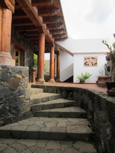 a stone stairway leading to a house with a building at Hotel Estancia de la Era B&B in Pátzcuaro
