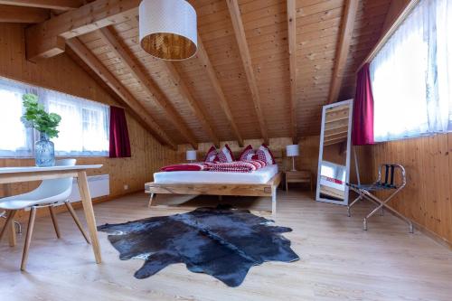 Schlafzimmer mit einem Bett, einem Schreibtisch und einem Tisch in der Unterkunft Chalet Wäschhüsli near Interlaken, Grindelwald and Lauterbrunnen in Gsteigwiler