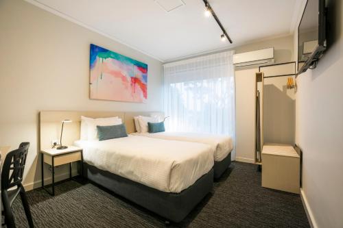 a hotel room with a bed and a window at Nightcap at Playford Tavern in Elizabeth