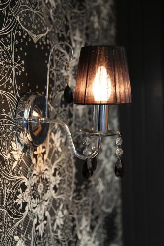 a lamp attached to a wall with a wallpaper at Siesta Villa in Jindabyne