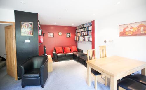 a living room with a table and chairs and a couch at Honest University Apartment 2 in Southampton