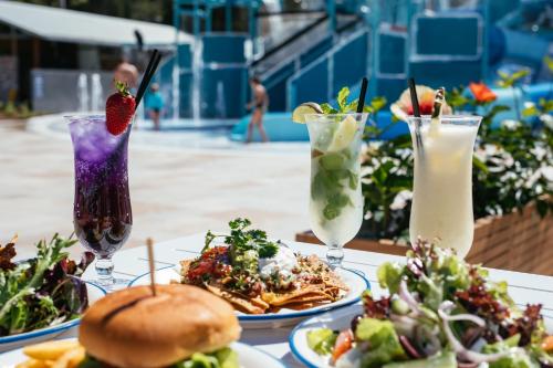 a table topped with plates of food and drinks at BIG4 Sandstone Point Holiday Resort Bribie Island in Bongaree