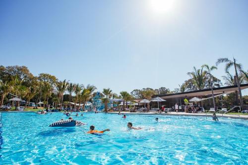 a group of people in a pool at a resort at BIG4 Sandstone Point Holiday Resort Bribie Island in Bongaree