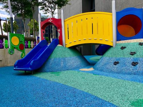 a playground with a slide on a blue carpet at CoZy Suite @ PJ & Sunway(2 Bedroom) in Petaling Jaya