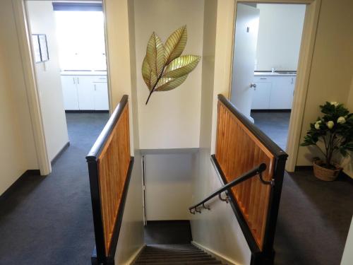 a staircase in a building with two doors and a stair case at Admirals Motor Lodge in Blenheim
