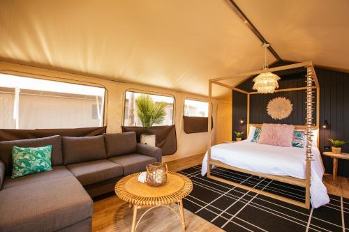 a living room with a couch and a bed at BIG4 Sandstone Point Holiday Resort Bribie Island in Bongaree