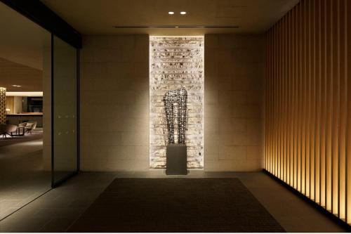 a hallway with a wall with a stone wall at The Prince Sakura Tower Tokyo, Autograph Collection in Tokyo